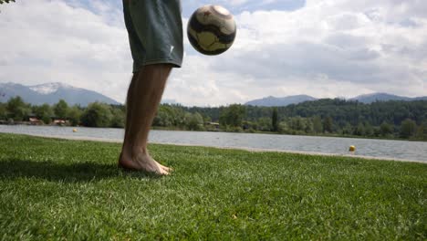 Close-up-caucasian-feet-juggling-with-a-ball-in-a-park-in-Europe