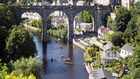 Knaresborough-people-in-rowing-boats-on-the-river-Nidd-having-fun-during-summertime-high-viewpoint-showing-the-railway-viaduct