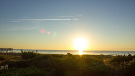 Golden-Sun-Rising-Over-Calm-Beach-At-Dawn