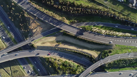 Static-aerial-perspective-looking-directly-down-as-traffic-moves-along-highway-interchange-onto-their-destination