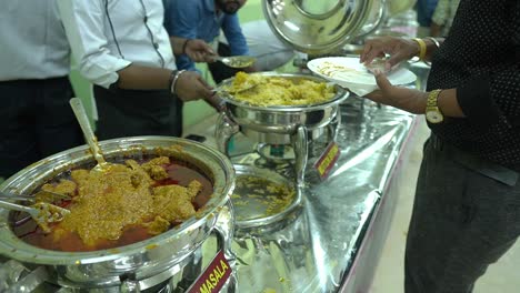 The-caterer-serving-mutton-biryani-to-guest-in-a-Indian-wedding.