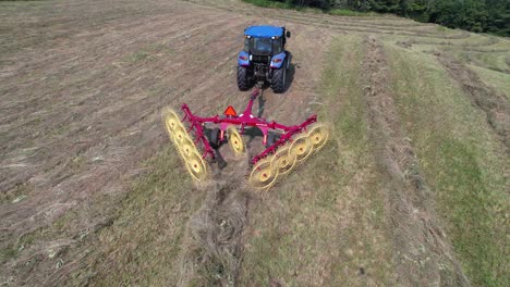 hay-rake-in-field-in-action-aerial-in-watauga-county-nc,-near-boone-nc,-north-carolina