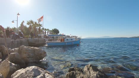 People-walk-promenade-along-Aegean-Sea,-Bodrum,-Turkey