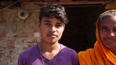 Mother-with-teenage-daughter-and-son-looking-at-camera,-Rajasthan