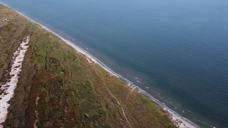Aerial-beautiful-view-of-the-Black-Sea-with-waves-hitting-the-wild-shore-of-the-Vadu-beach,-Romania,-Europe