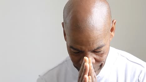 man-praying-to-god-with-hands-together-Caribbean-man-praying-with-grey-background-stock-video