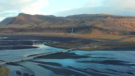 Panoramic-view-of-Seljalands-River-and-Seljalandsfoss-cascade-in-Thorsmork-area,-aerial-shot-of-Iceland-region