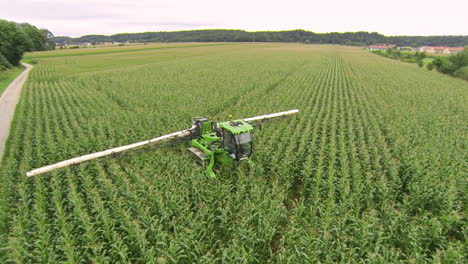 Sprayer-moving-through-corn-field,-applying-crop-protection