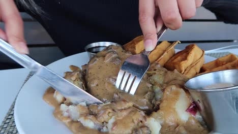 Cutting-Vegan-Chicken-Waffles-with-Gravy-and-Mashed-Potato