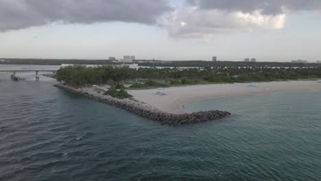 Aerial:-Lone-man-tosses-fish-net-from-beach-at-Haulover-Beach-Dog-Park