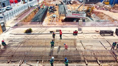 Workers-prepare-steel-and-rebar-reinforcement-cages-for-diaphragm-wall-subway-construction