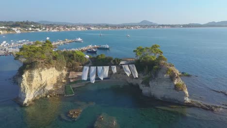 Aerial-drone-footage-of-a-Beach-Club-on-Cameo-Island-in-Zakynthos,-Greece