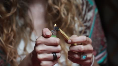 Hippie-Girl-Burning-Piece-of-Wood-with-Lighter,-Basic-Elements-of-Life