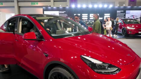 Visitors-try-a-Tesla-Motor-model-Y-at-the-American-electric-company-car-Tesla-Motors-booth-during-the-International-Motor-Expo-showcasing-EV-electric-cars-in-Hong-Kong
