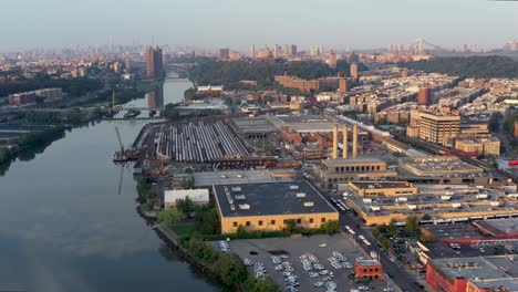 Trucking-shot-over-industrial-section-of-Inwood-Manhattan-Bronx-New-York-City-at-golden-hour