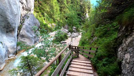 POV-shot-of-someone-walking-down-wooden-stairs-in-a-beautiful-canyon
