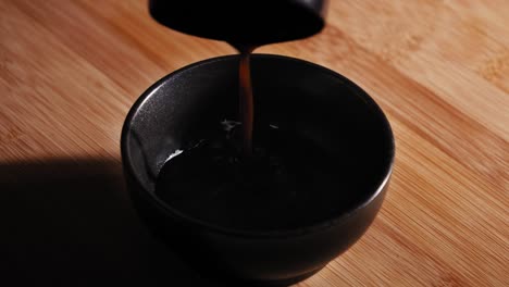 Pouring-Soy-Sauce,-Worcester-Sauce,-And-Water-Into-A-Bowl-Then-Add-A-Teaspoon-Of-Black-Pepper