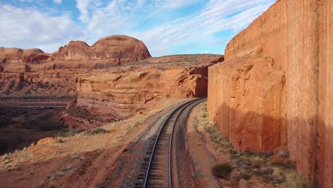 Aeriel-top-view-empty-straight-single-way-railways-at-summer-sunny-day-in-red-rock-canyon-in-Las-Vegas,-Nevada,-USA-with-endless-railway-without-train