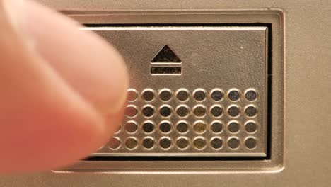 Extreme-close-up-of-an-Eject-button-A-finger-pushes-it-and-then-pushes-the-button-aggressively