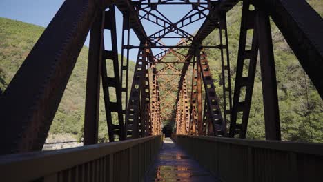 Old-Iron-Railway-Bridge,-Tilt-Reveal-Over-Empty-Hiking-Trail,-Takedao-Japan