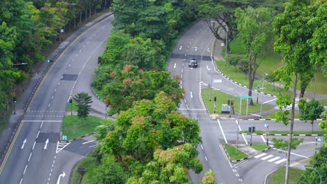 Morning-traffic-at-Anderson-Road,-beautiful-green-tropical-forest