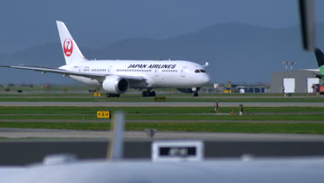 Japan-Airways-Plane-Traversing-Terminal-Route-In-Vancouver-International-Airport---wide-shot