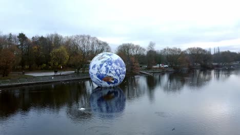 Luke-Jarram-floating-earth-art-exhibit-aerial-view-Pennington-flash-lake-nature-park-low-orbit-right