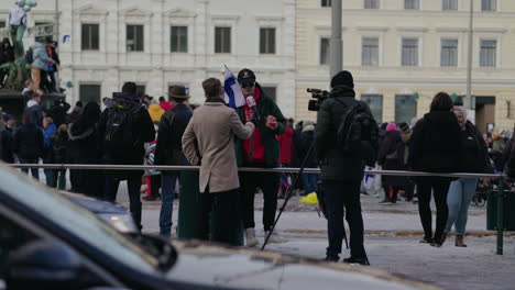 Interview-of-Fans-celebrating-Olympic-Ice-hockey-championship,-at-the-market-square,-in-Helsinki,-Finland