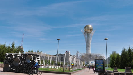 Bayterek-monument-observation-tower-with-golden-crowned-ball-on-top,-symbol-of-Nur-Sultan-Astana-city-capital,-gimbal-shot