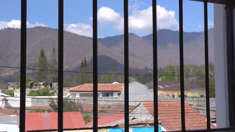 Looking-out-of-window-with-bars-in-Latin-America