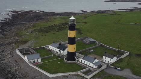 Aerial-view-of-St-John's-Point-lighthouse-on-a-cloudy-day,-County-Down,-Northern-Ireland