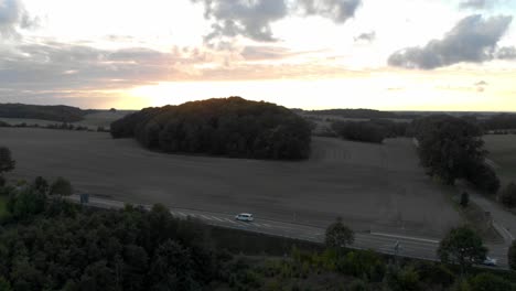 aerial-drone-flight-next-to-a-road-while-sunset