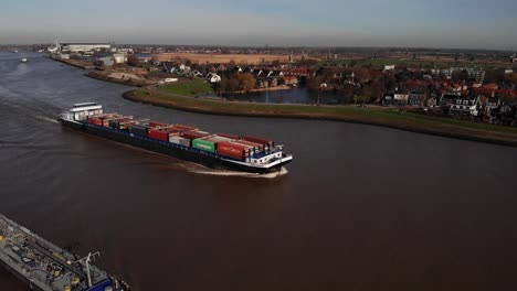 Aerial-View-Of-Missouri-Carrying-Shipping-Containers-Along-River-Noord