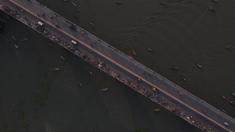 People-and-cars-crossing-river-on-a-bridge