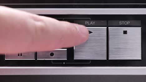 Extreme-close-up-of-buttons-on-an-old-antique-or-vintage-VCR-Pushing-the-play-button-a-bunch-of-times-or-aggressively