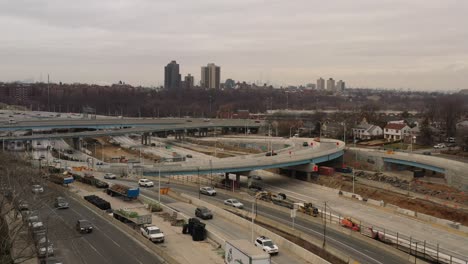 An-aerial-view-of-a-highway-intersection-with-flowing-urban-traffic-on-a-cloudy-Sunday-afternoon-in-winter