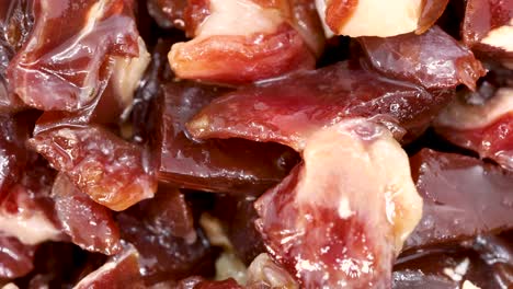 Serrano-ham-chopped-in-small-pieces-close-up-view,-macro-shot-in-4k