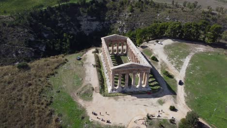 Slow-Turning-Aerial-of-an-Ancient-Greek-Temple-in-the-Sunlight-with-a-Lush-Gorge