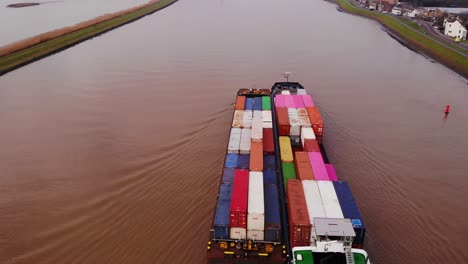 Aerial-Over-Excelsior-Cargo-Ship-And-Barge-Transporting-Cargo-Containers-On-River-Noord-Past-Crezeepolder