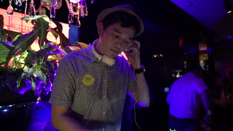 Asian-DJ-spinning-tunes-in-a-bar
