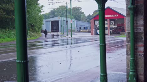Workman-heads-towards-Northern-bus-tram-depot-on-rainy-wet-day