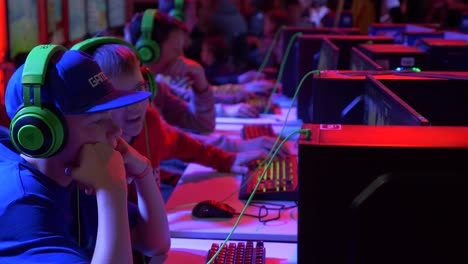 Slow-motion-camera-view-of-young-boys-playing-computer-games-at-e-sport-festival