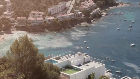 Panorama,-luxurious-houses-by-Spanish-European-coast-next-to-beach-with-ocean-views