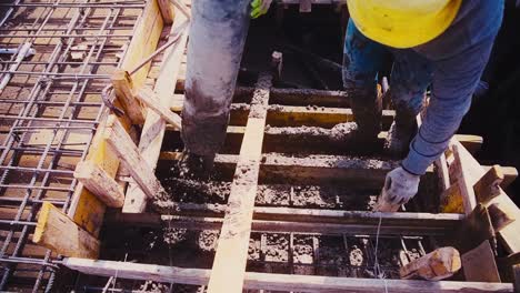 Construction-builder-holding-a-Concrete-Pump-Hose-in-a-construction-site