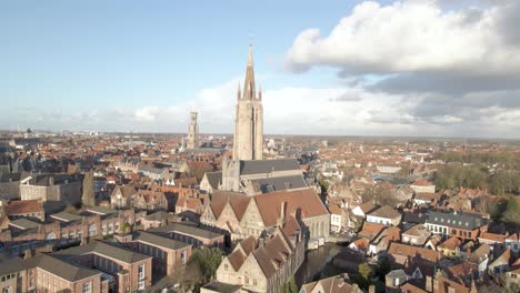 Slow-reveal-drone-shot-of-Our-Lady-Church-in-Bruges-Belgium-on-a-Sunny-day