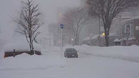 Heavy-Snow-Over-Roads-as-Cars-Drive-Slowly-Down-The-Street