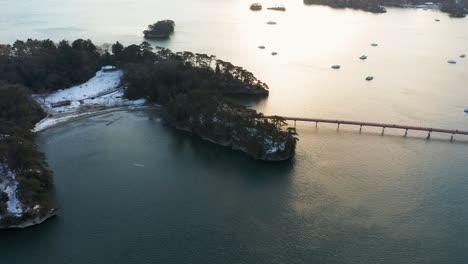 Matsushima-Bay-Aerial,-Snow-at-Sunset-Over-Fukuurajima-Island,-Miyagi-Japan
