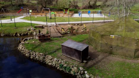 Pan-Right-View-Across-Animal-Reserve-Surround-By-Pond-With-Children's-Play-Park-In-Background-At-Ordes-Park-In-Coruna