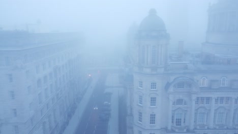Ghostly-dense-city-fog-aerial-view-down-chilling-downtown-cityscape-streets-dolly-left