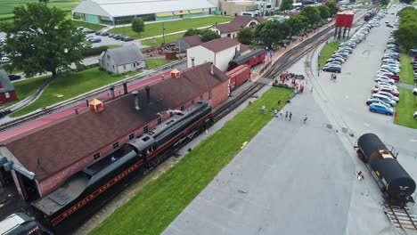 An-Aerial-View-of-an-Antique-Steam-Passenger-Train-Pulling-into-Train-Station